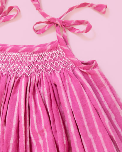 Close-up of hand-smocked yoke on taffy pink striped baby dress in soft breathable Jaipur cotton perfect for girl baby