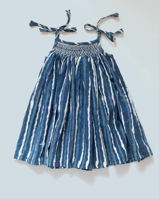 Hand-smocked Jaipur cotton baby dress in indigo stripe with tie-up shoulders for newborn girls by MyBud